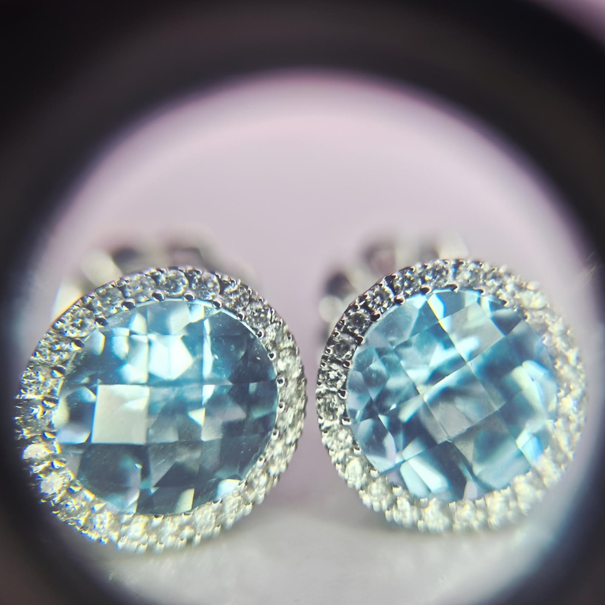 18ct white gold hallmarked aquamarine and diamond halo cluster earrings under eyeglass