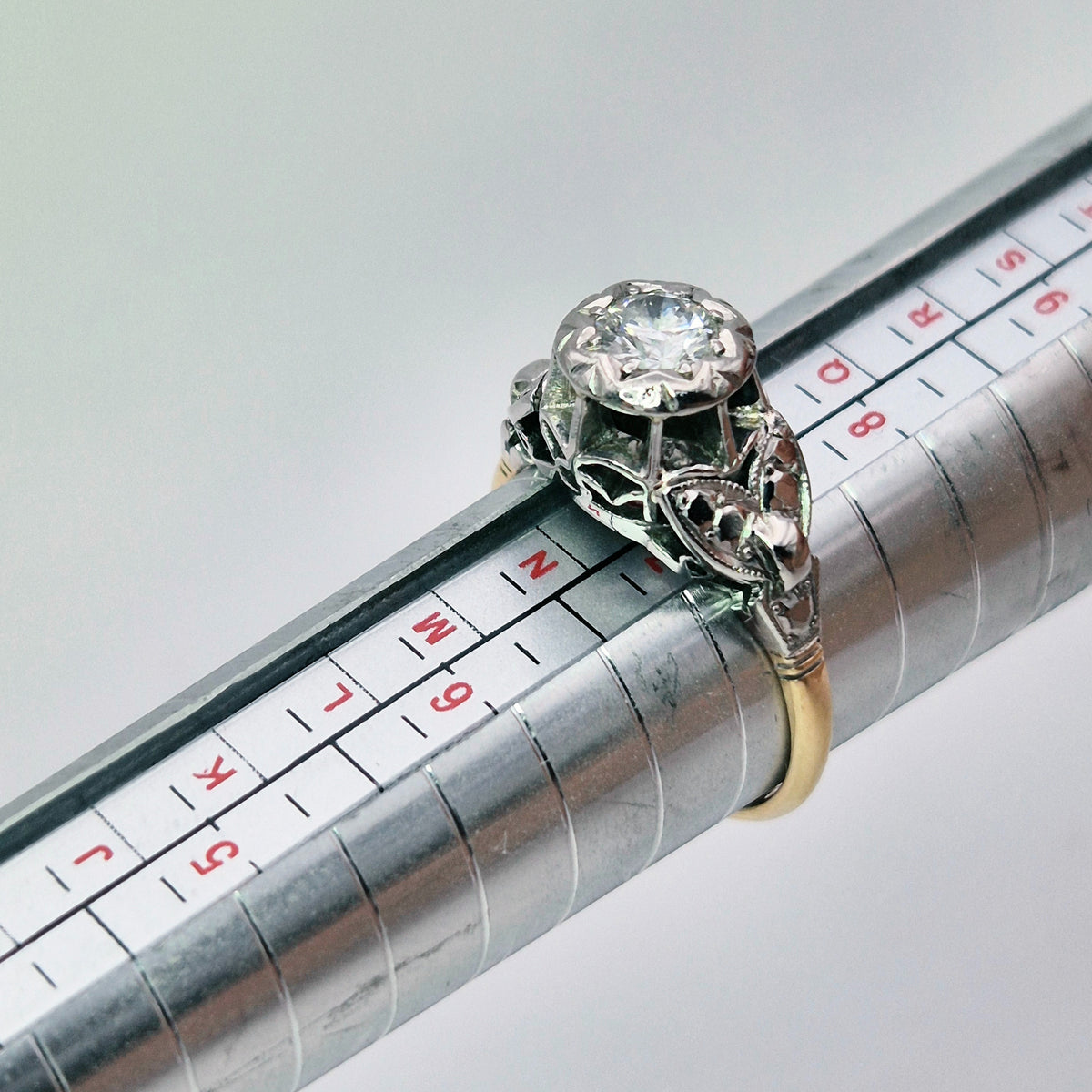 18ct yellow gold and platinum collet single stone diamond ring on ring stick