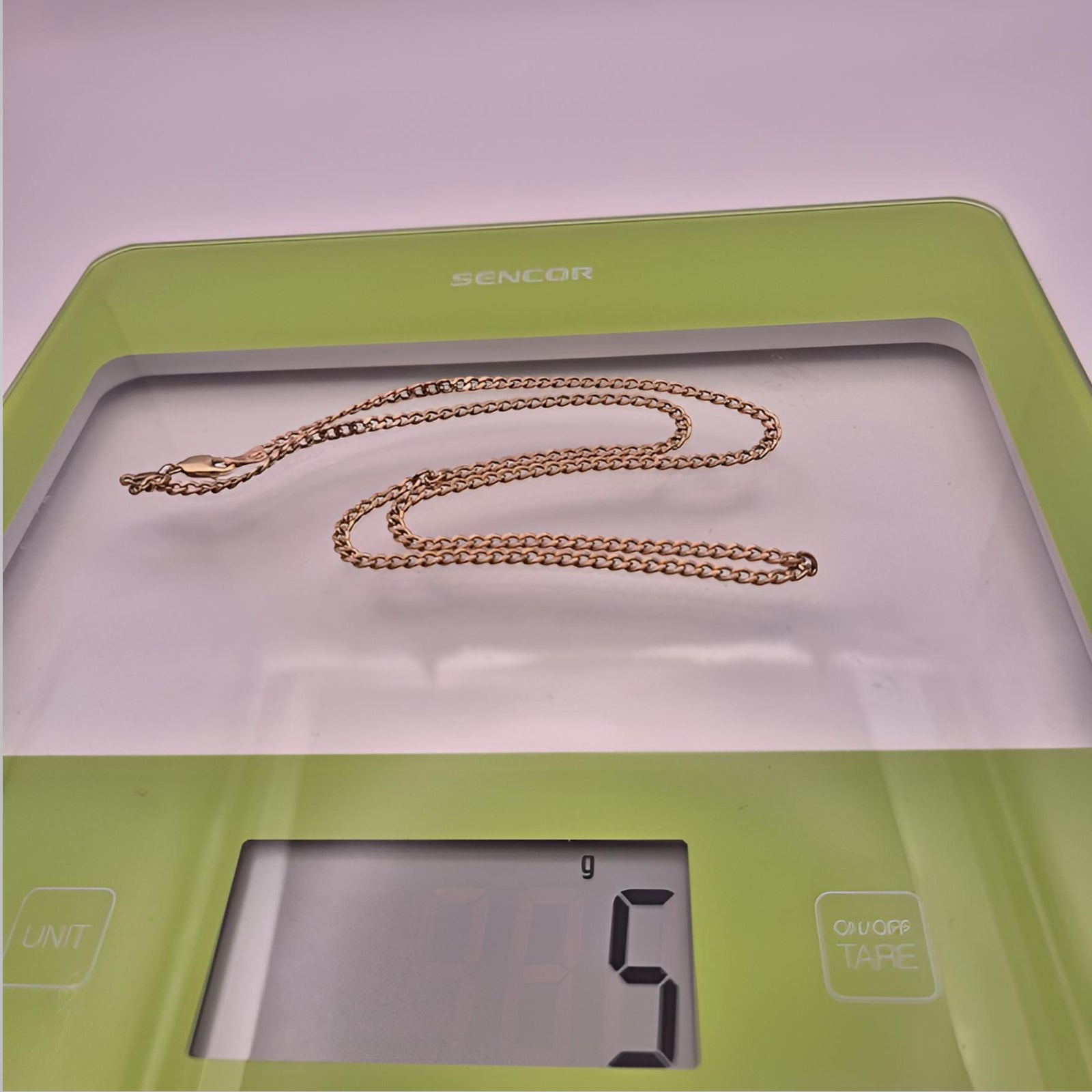 Gold chain on a digital kitchen scale 5g