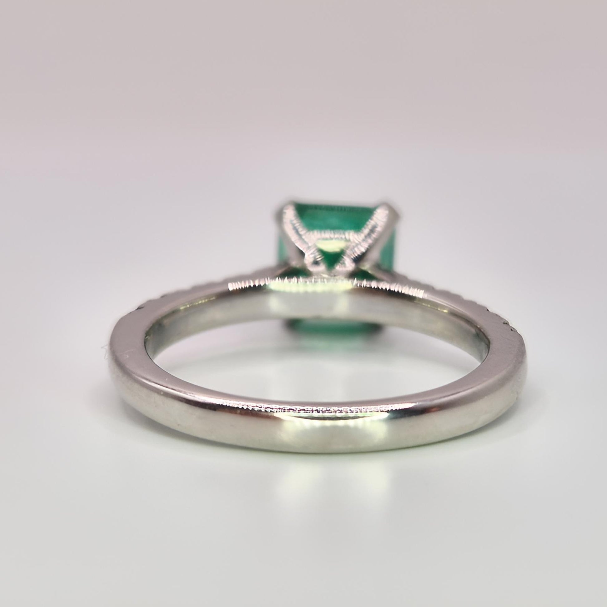buish green emerald ring behind