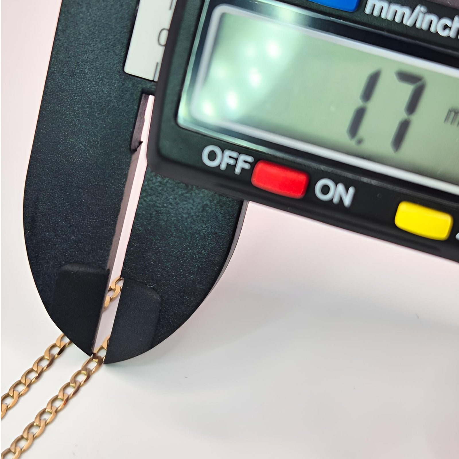 Digital caliper measuring a gold chain with a displayed measurement of 1.7 mm.