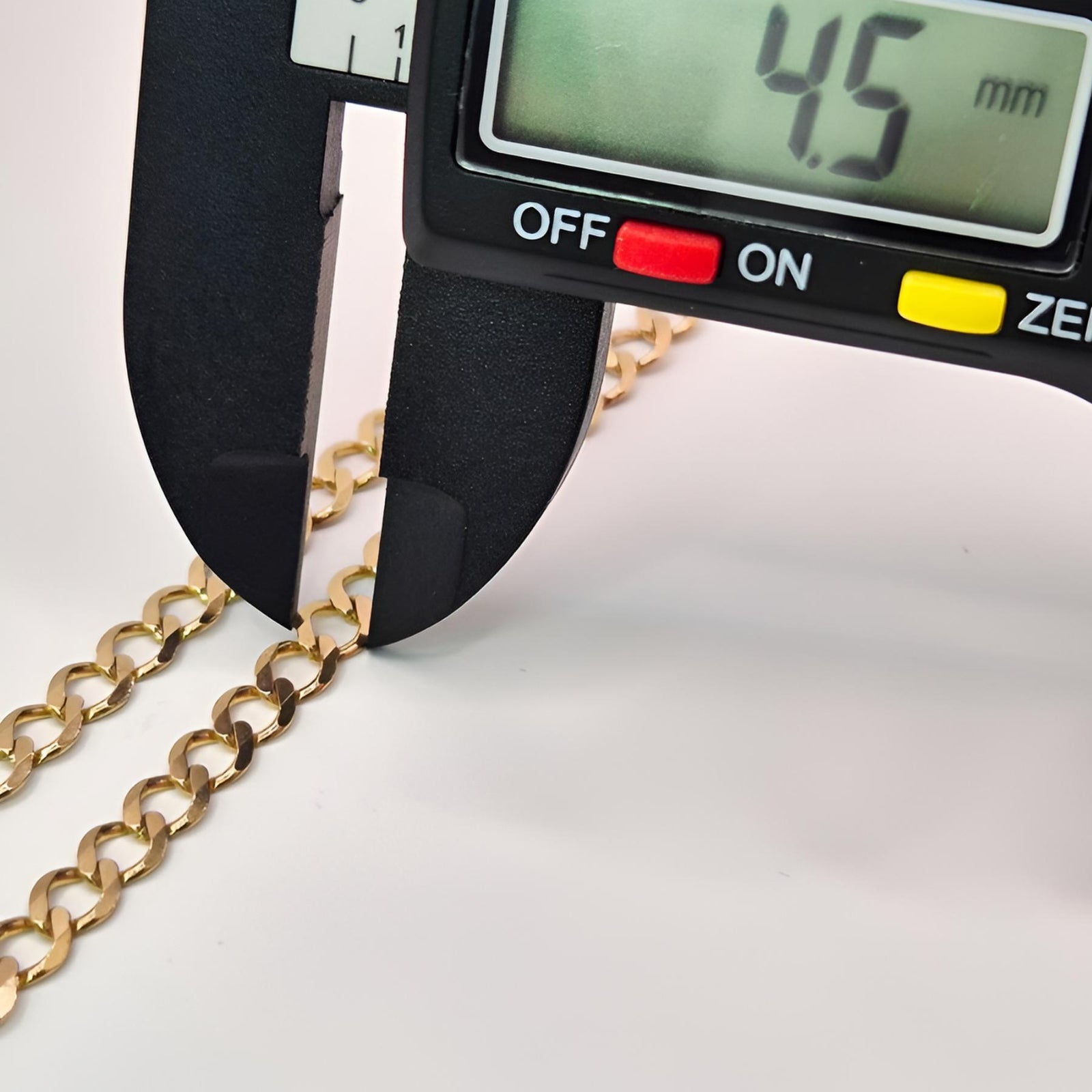 Digital caliper measuring a gold chain with a displayed measurement of 4.5 mm on a white background.
