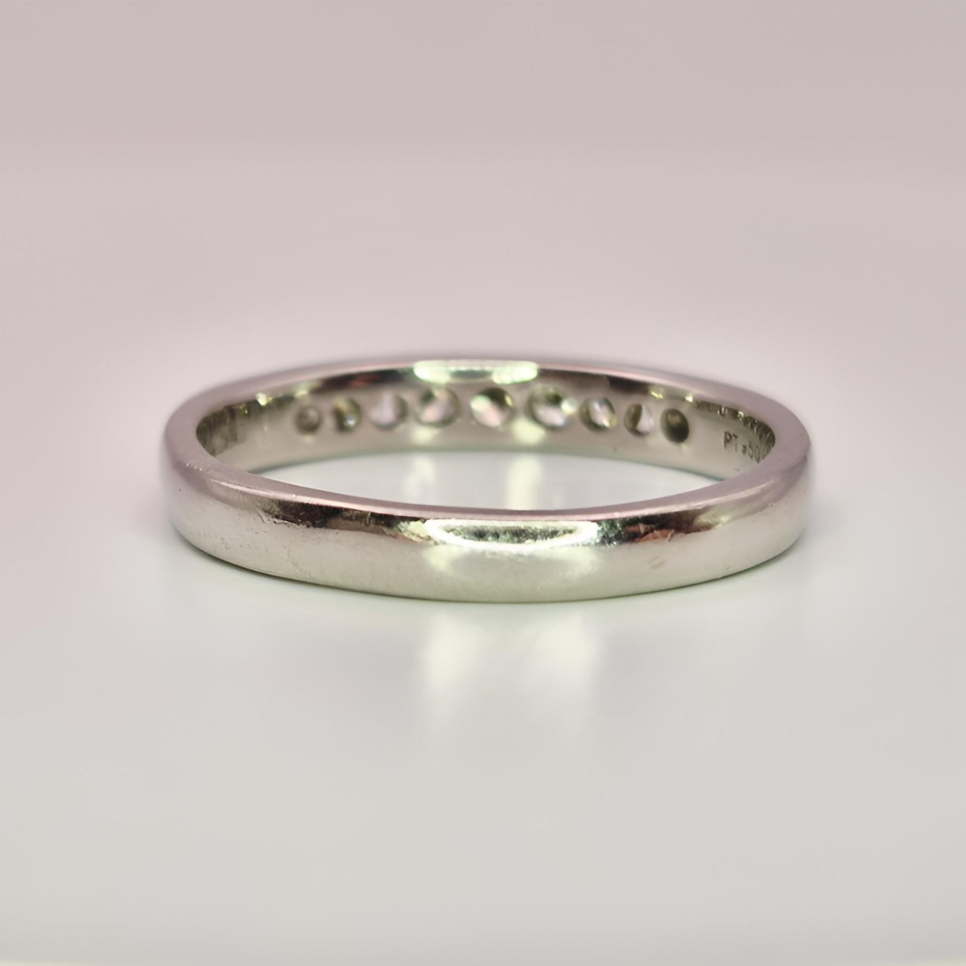 platinum hallmarked diamond half eternity ring behind view