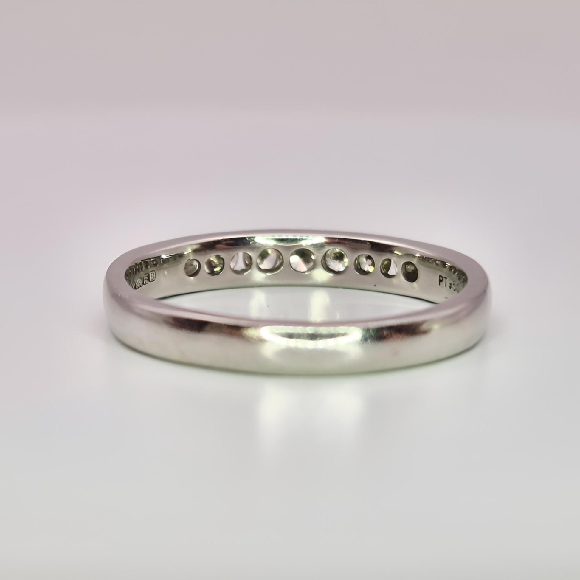 platinum hallmarked diamond half eternity ring behind