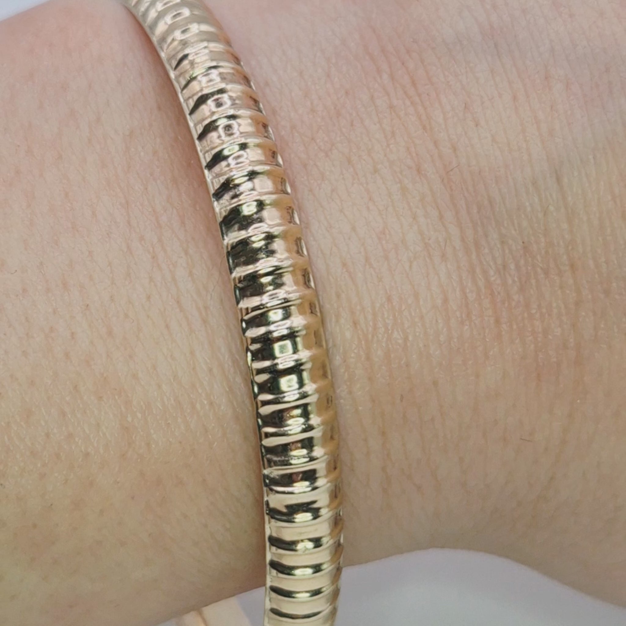 9ct gold patterned bangle hallmarked wearing on wrist